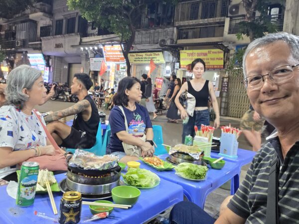 Day 3 - Having our late hot plate dinner along Hanoi street, sitting on small plastic chairs and tables